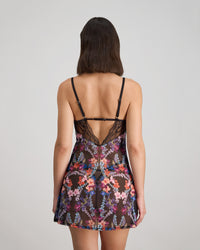 Model wears Adaline Chemise in BLACK FLORAL PRINT. On body back view