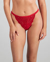 Model wears Lace Me Up Thong in JESTER RED. On body front view