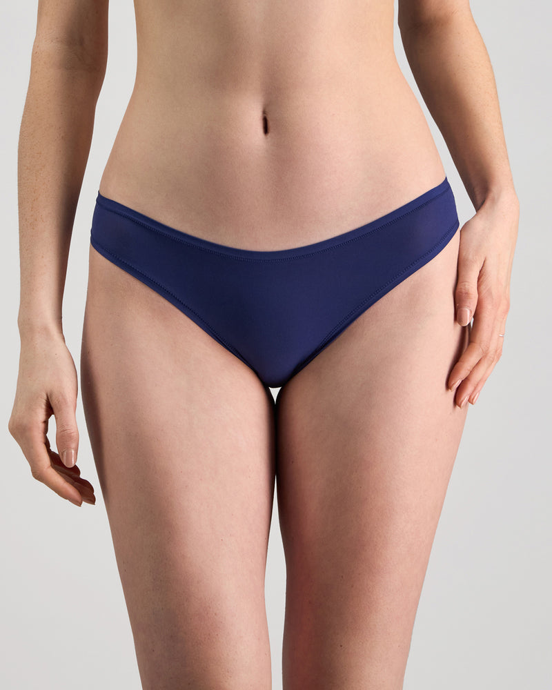 Model wears Extra-Ordinary Bikini Brief in Medieval Blue. On body front view