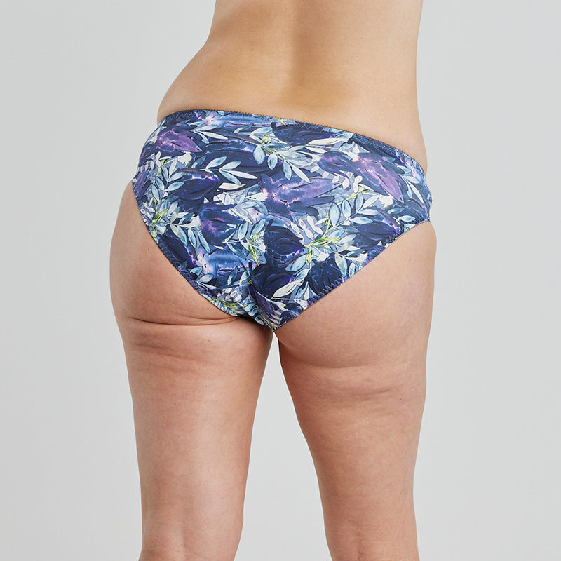 Model wears Violet Floral High Cut Brief in DARK PROTEA PRINT. On body back view