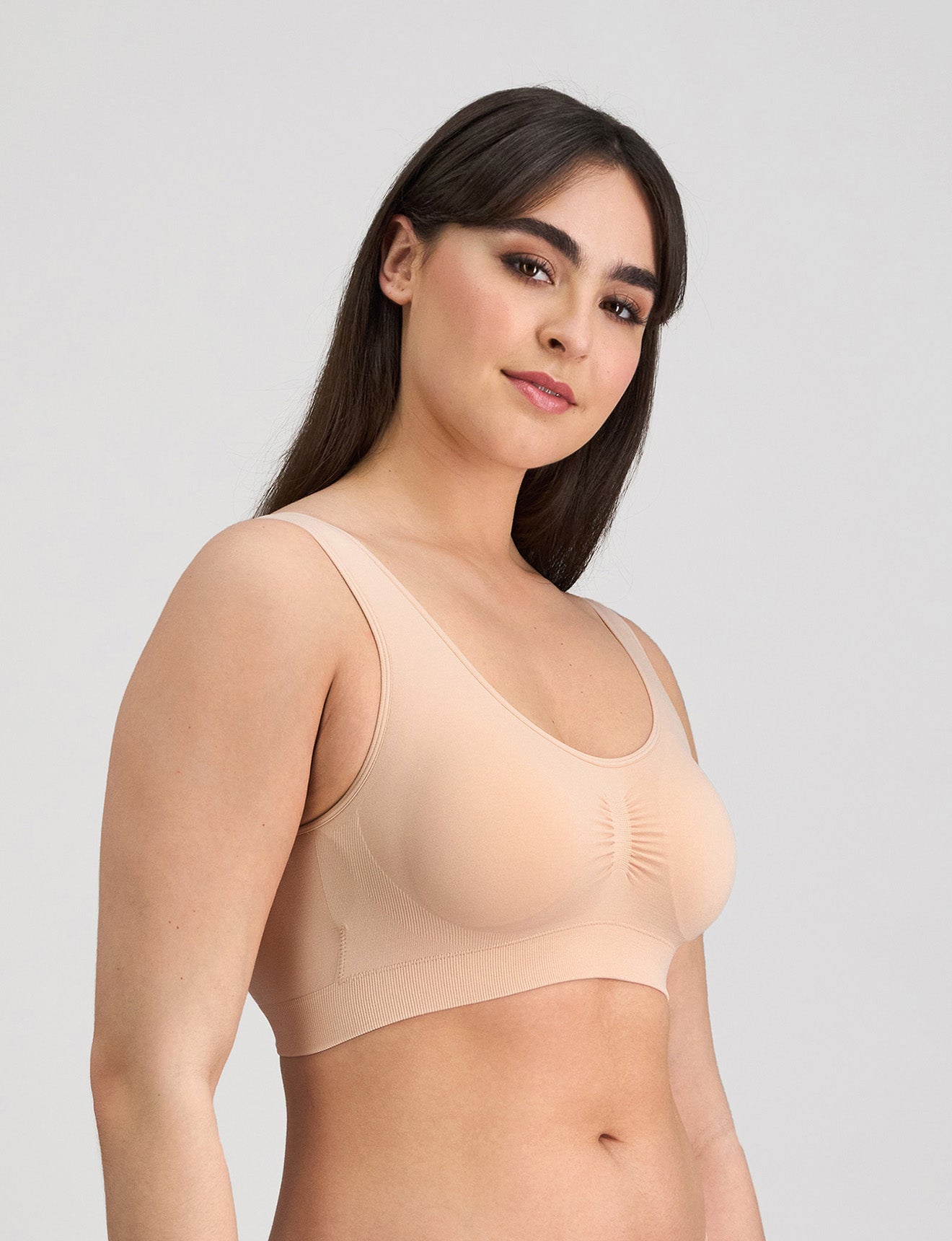 Model wears Bendon Essentials Strapless Bra in LATTE. On body side view