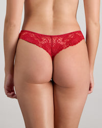 Model wears Adoration Thong in SALSA. On body back view
