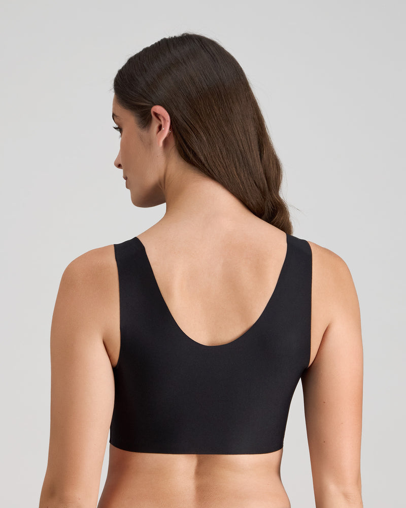 Model wears Comfit Collection Crop Top in BLACK. On body back view