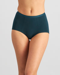 Model wears Body Cotton Full Brief in PONDEROSA PINE. On body front view