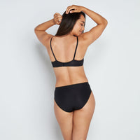 Model wears Freedom To Move High Cut Brief in BLACK. On body back view
