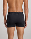 Model wears Cotton Classics Mens Trunk in BLACK. On body back view