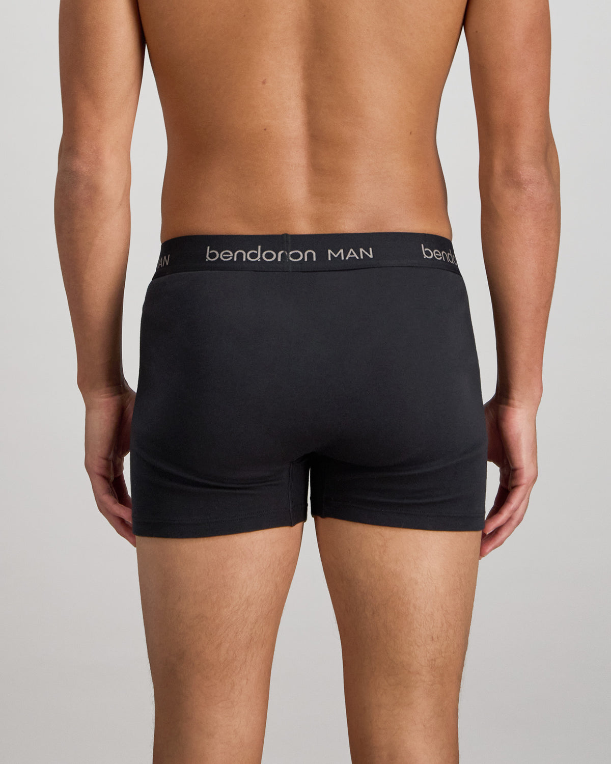 Model wears Cotton Classics Mens Trunk in BLACK. On body back view