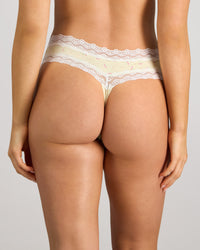 Model wears Daily Micro Thong in TRANSPARENT YELLOW. On body back view