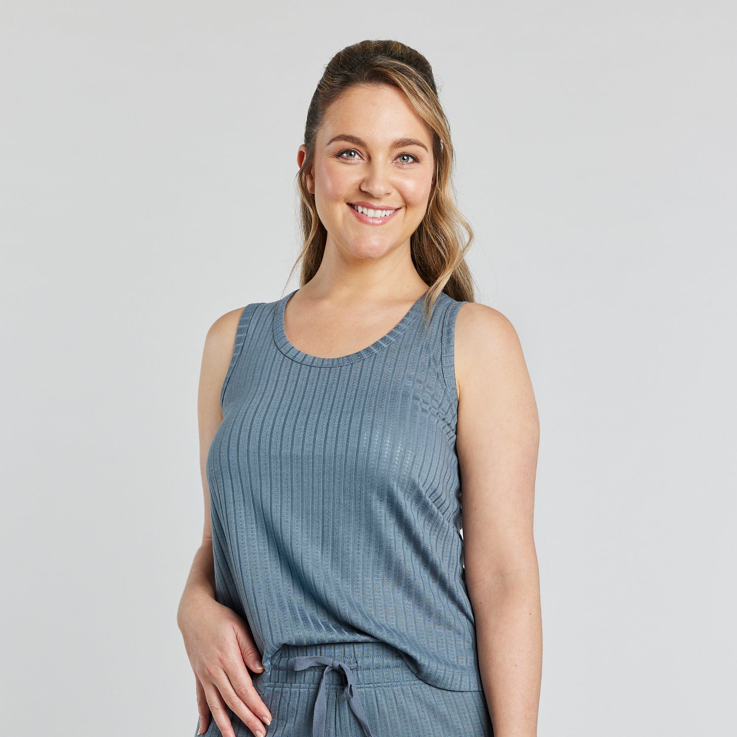 Model wears Charlene Singlet in EUCALYPTUS. On body front view