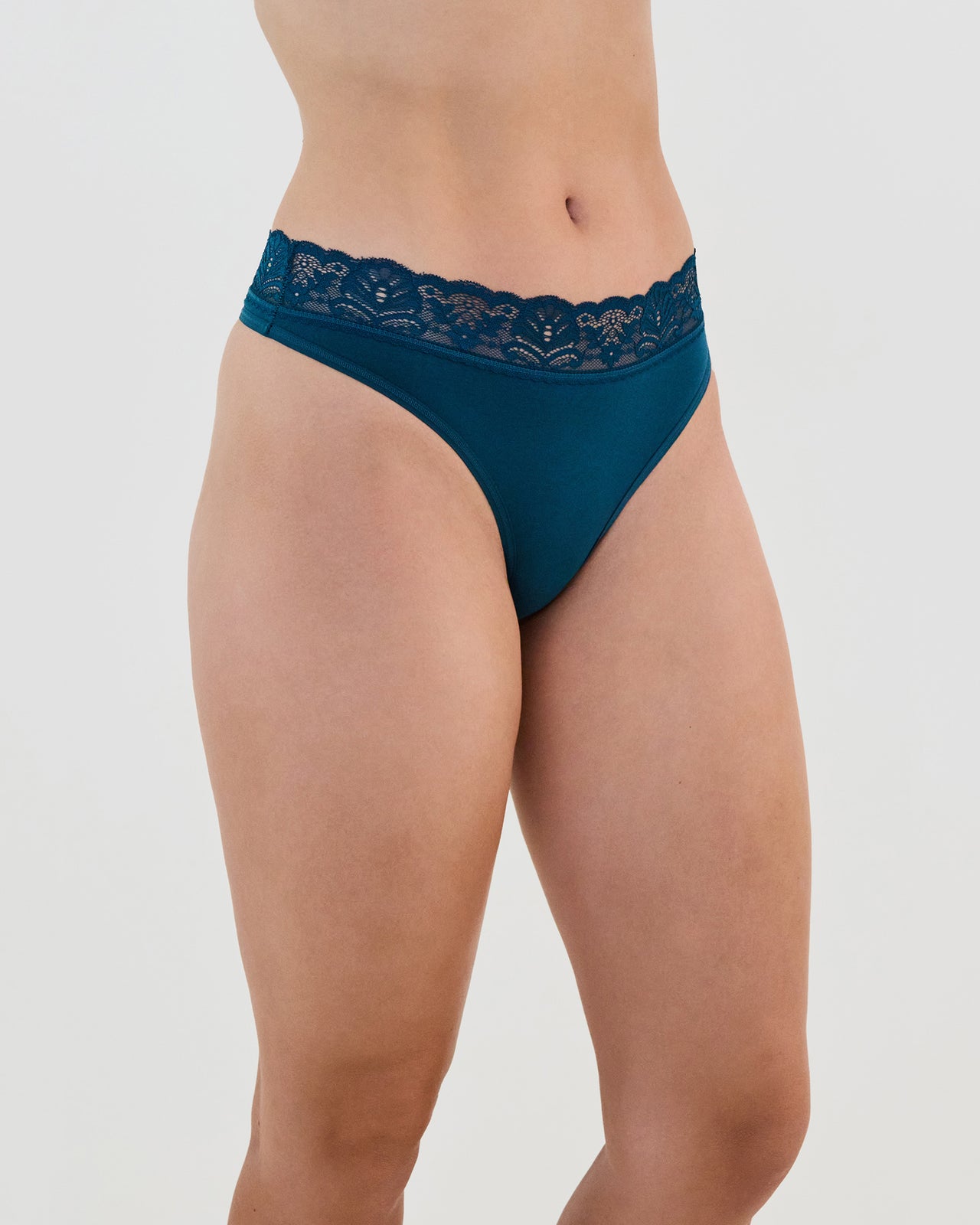 Model wears Cotton And Lace Thong in REFLECTING POND. On body side view
