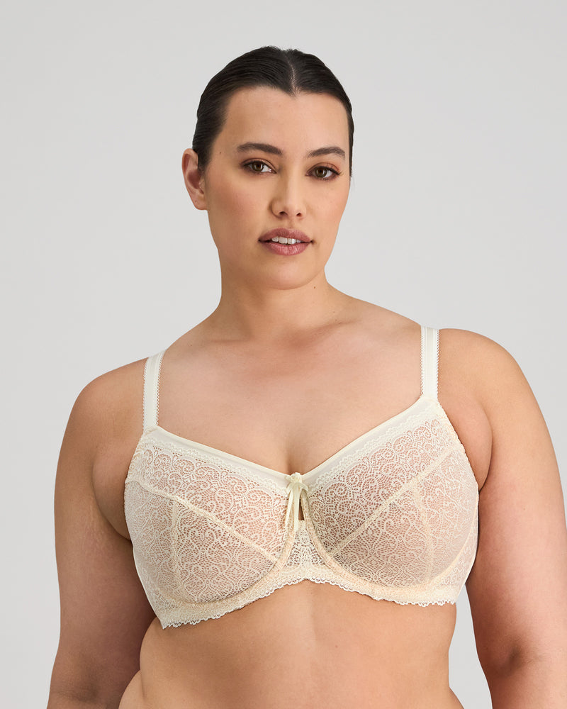 Model wears Delicate Lace Underwire Bra in IVORY/CREAM TAN. On body front view