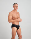 Model wears Cotton Texture Mens Brief in BLACK. On body side view