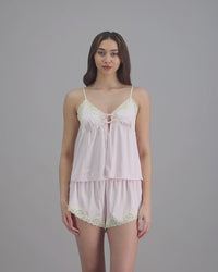 model-poses-in-light-pink-cami-and-short-set