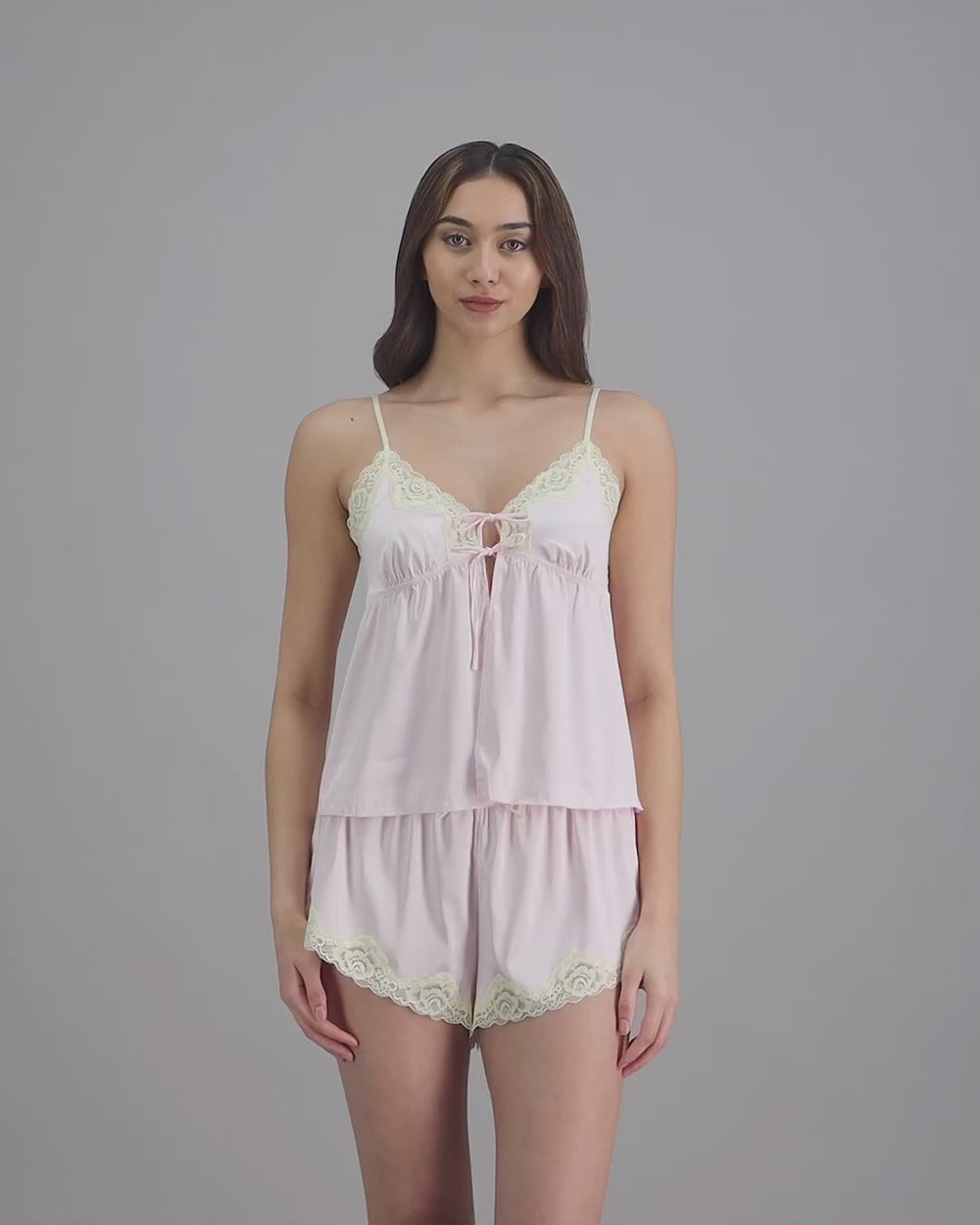 model-poses-in-light-pink-cami-and-short-set