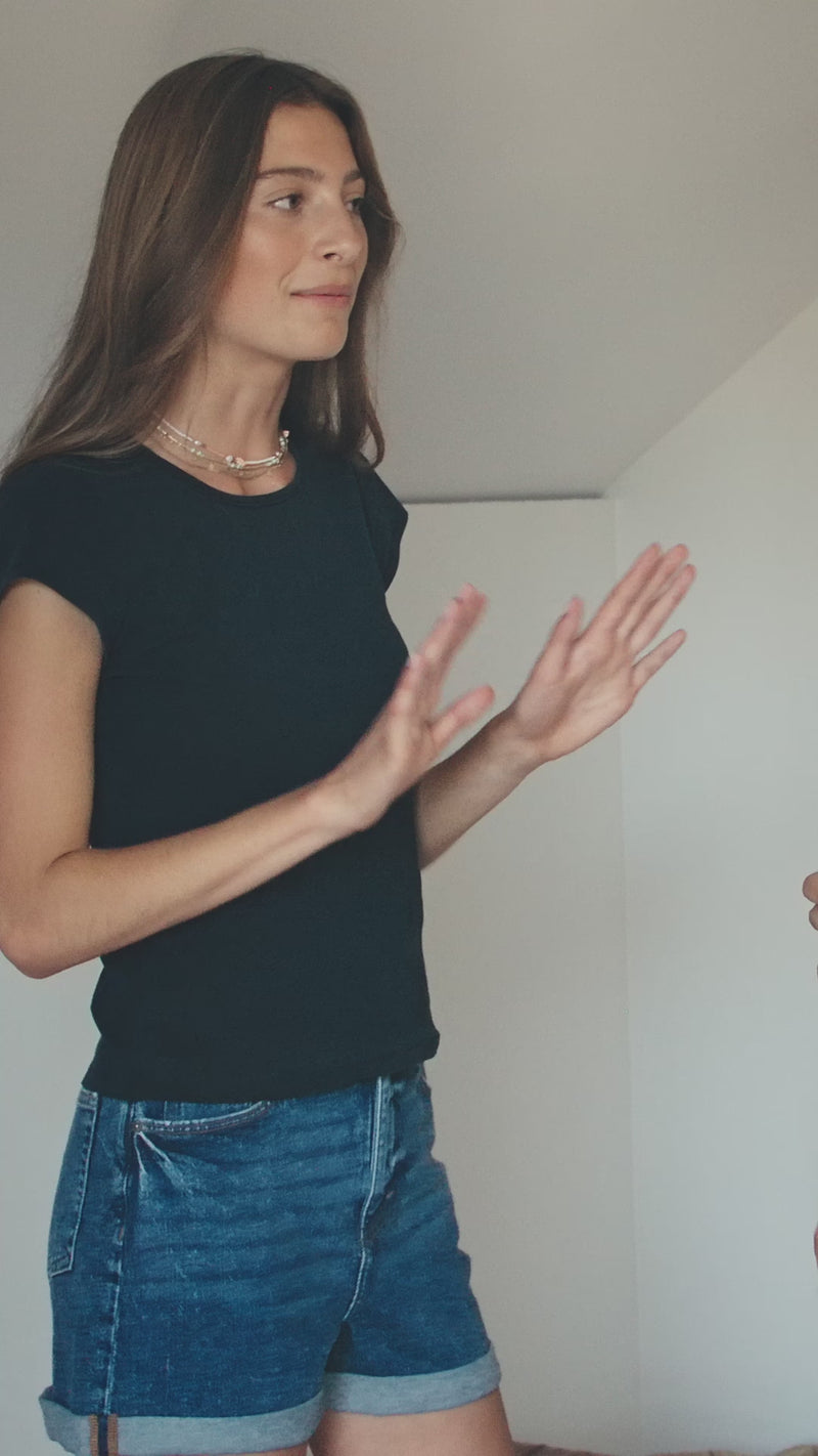model is being measured around bust for a bra fitting