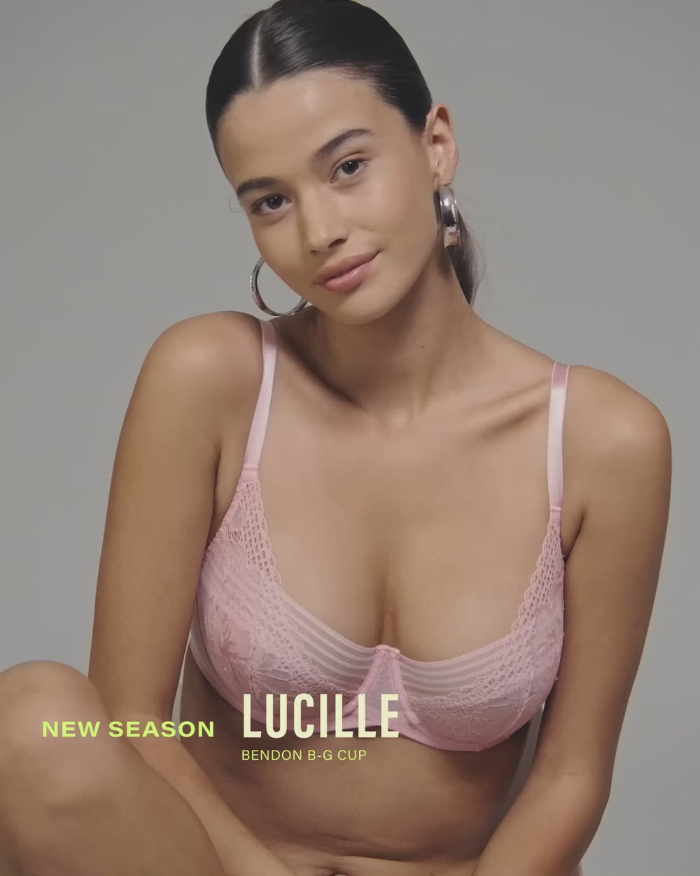 model-poses-on-chair-wearing-a-light-pink-lingerie-set