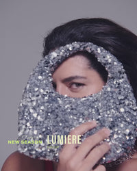 model-poses-in-red-lacey-bra-holding-silver-handbag