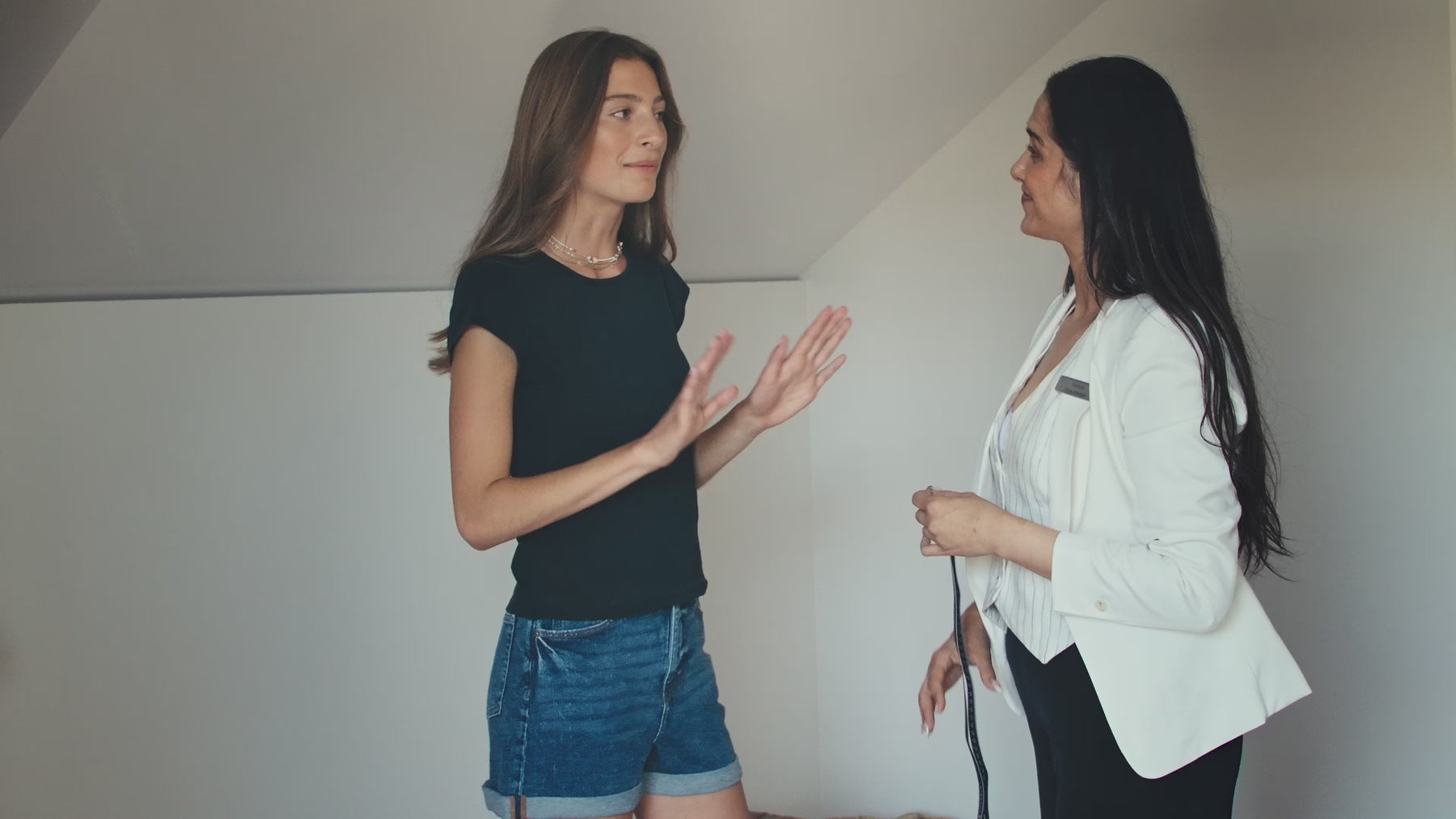 model is being measured around bust for a bra fitting
